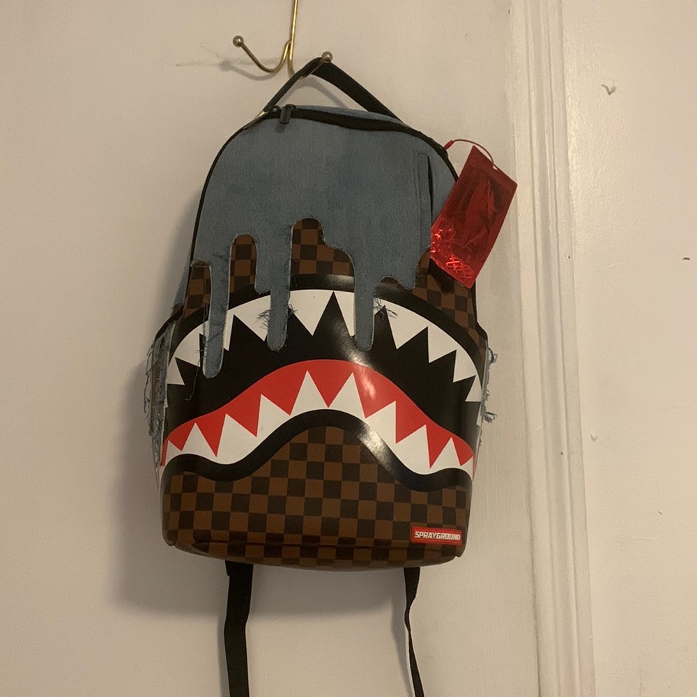 Spray ground denim book bag,like new,multiply pockets,great to use for school.